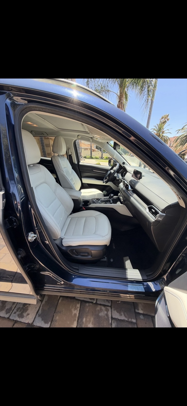 Freshly cleaned white leather front seats and interior of an SUV