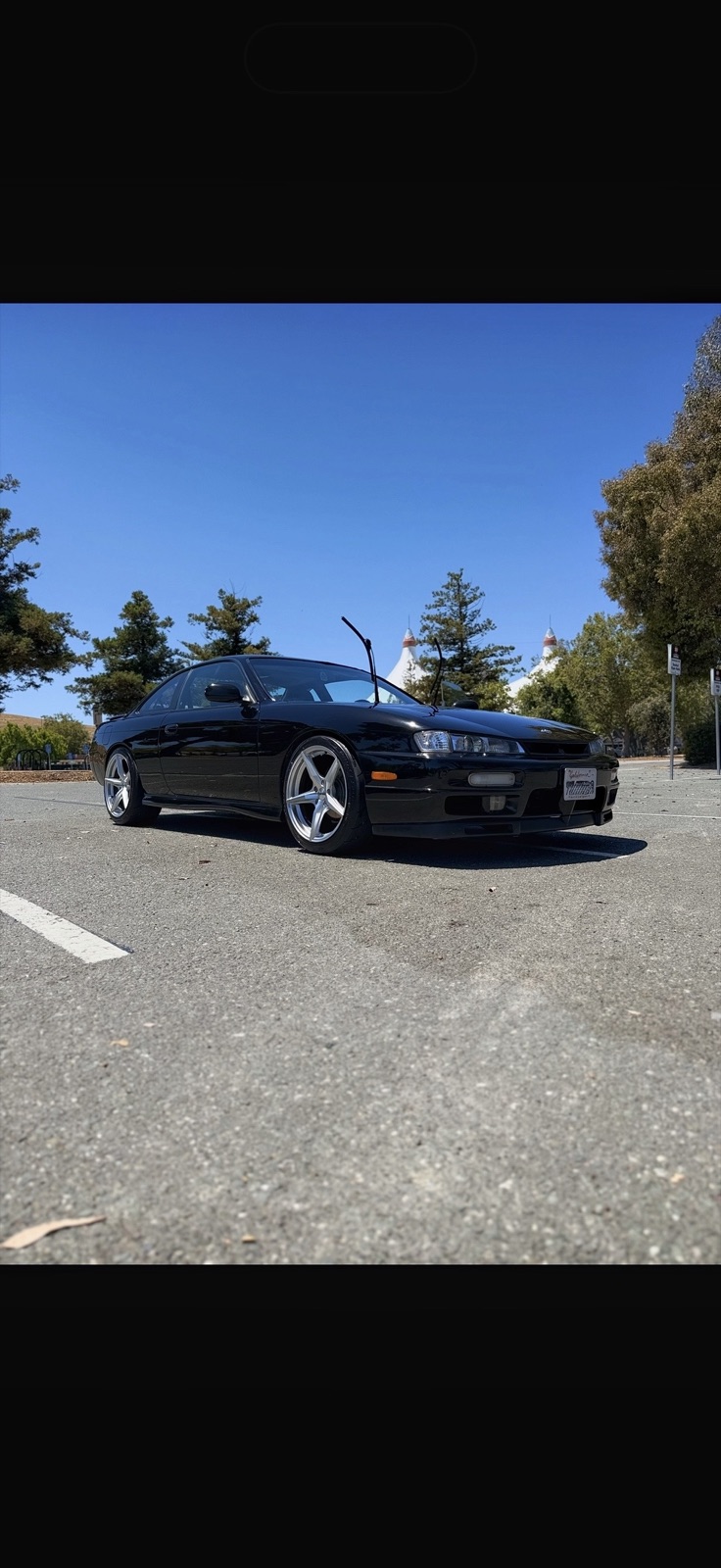 Black Nissan 240SX detailed on location in a parking lot