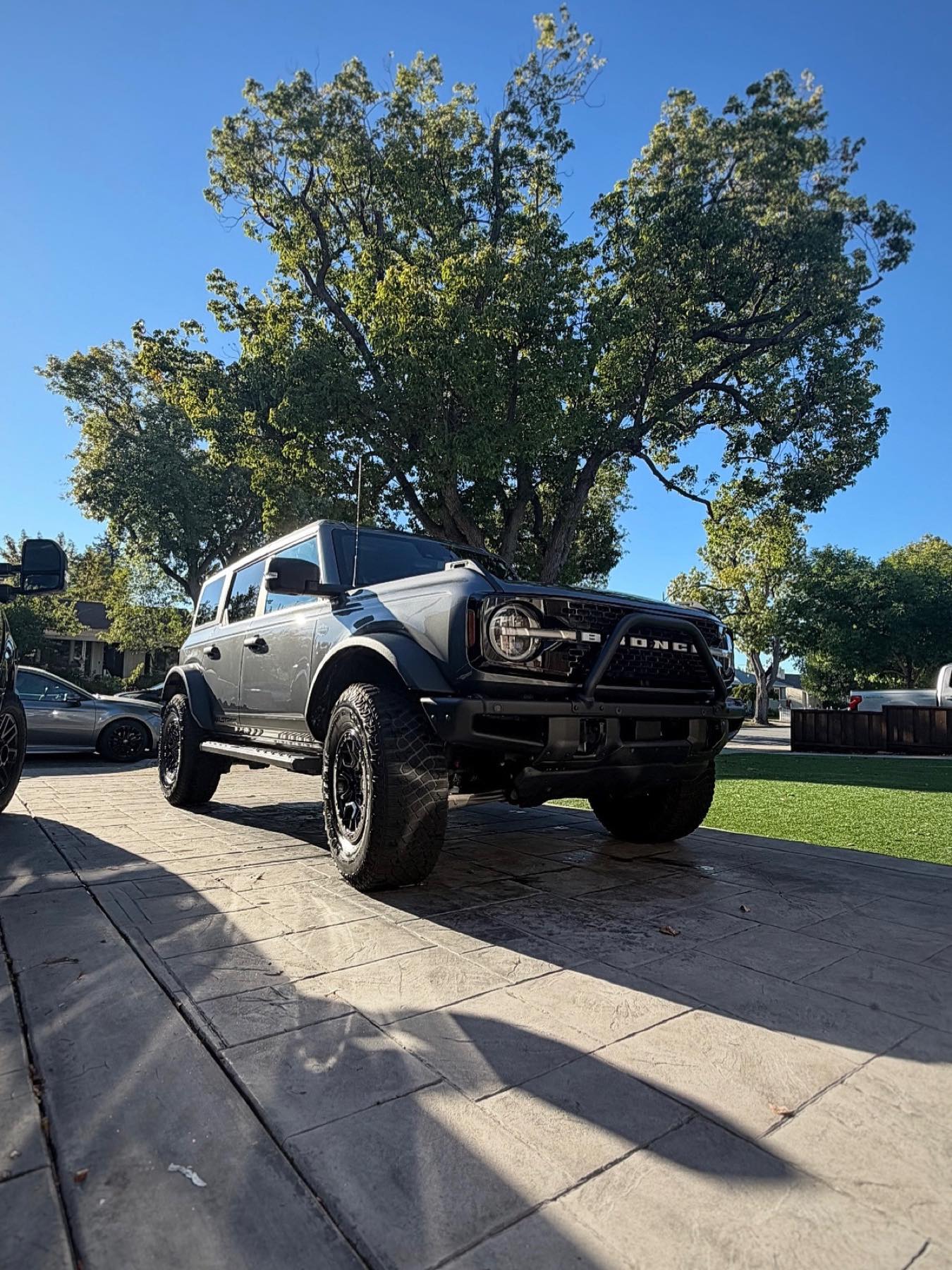 Freshly detailed gray Ford Bronco in golden evening light on a Bay Area driveway