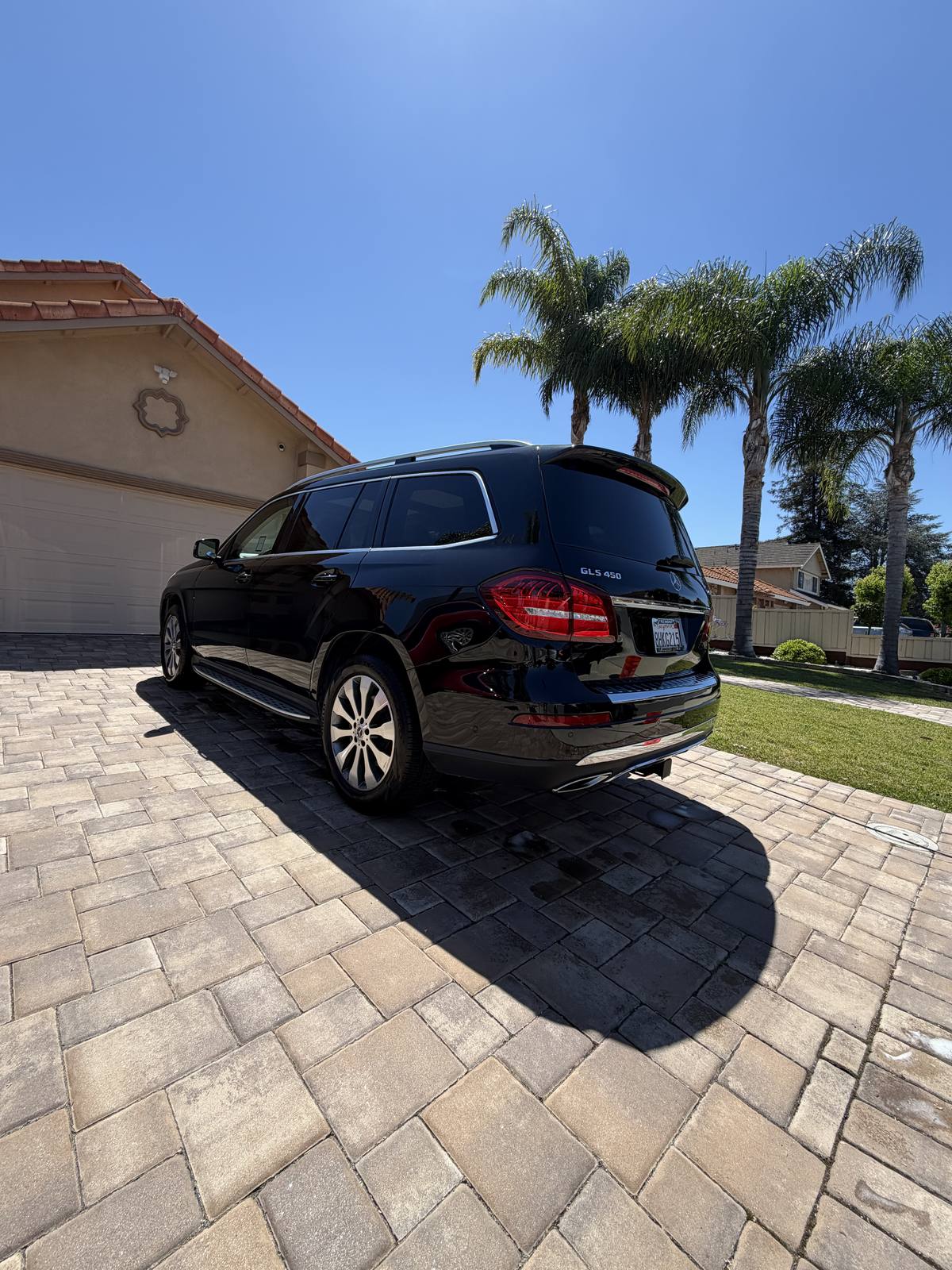 Deep gloss finish on a black Mercedes SUV after a full detail